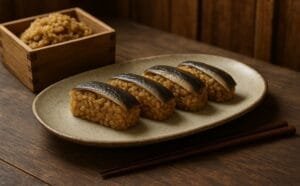 "Historical depiction of narezushi, the earliest form of sushi, showing fermented fish layered over aged rice in a wooden container – traditional Japanese setting."